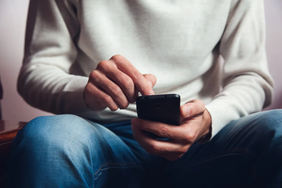 Hands scrolling on a smartphone